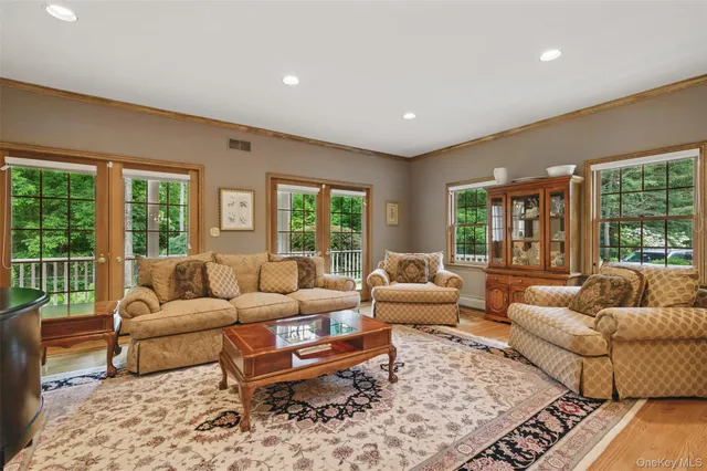 a living room with furniture a rug and a large window