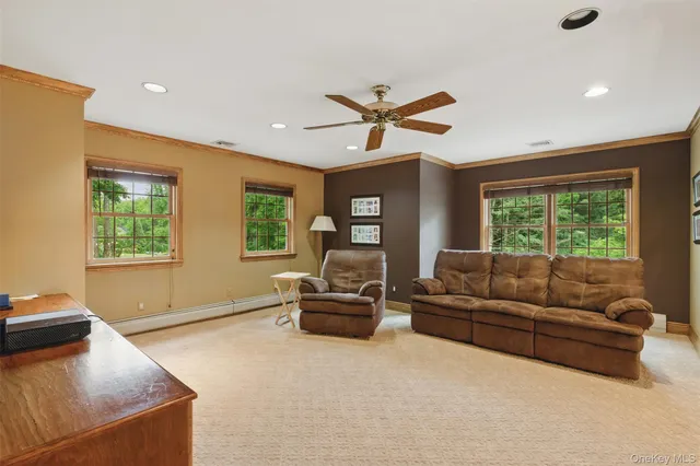 a bedroom with a large bed and large windows