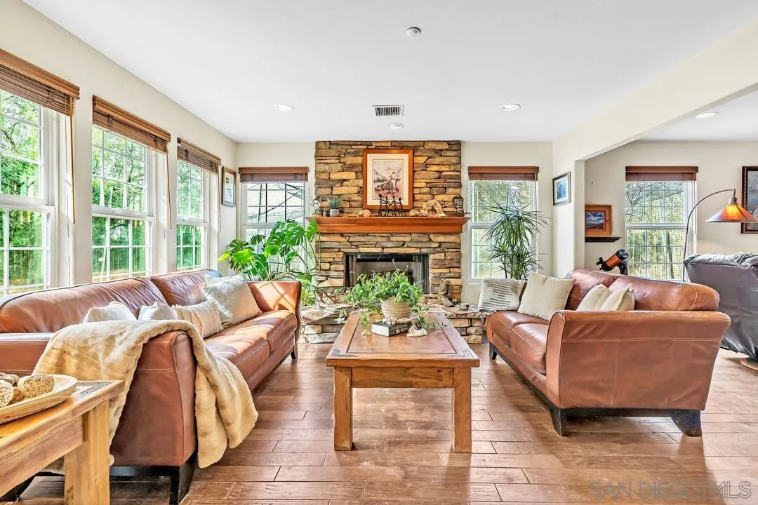 15127 Sycamore Canyon Road Poway, CA 92064 - Photo 14 of 47 a living room with furniture a fireplace and a large window