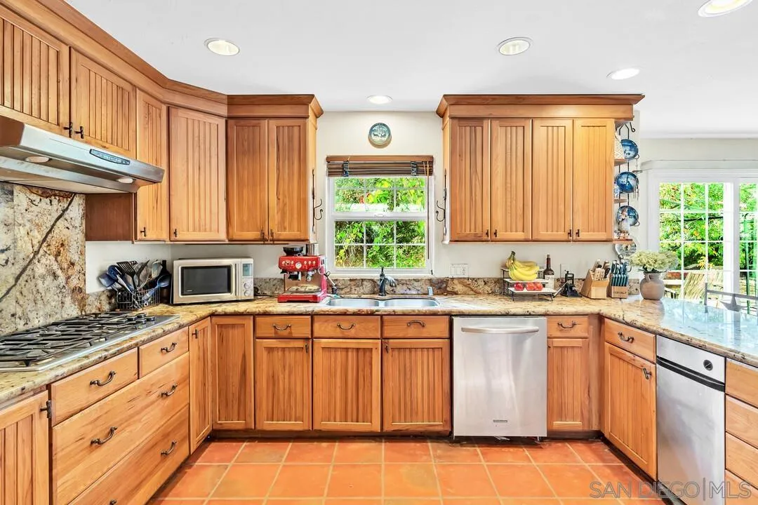 15127 Sycamore Canyon Road Poway, CA 92064 - Photo 21 of 47 a kitchen with stainless steel appliances granite countertop a sink and cabinets