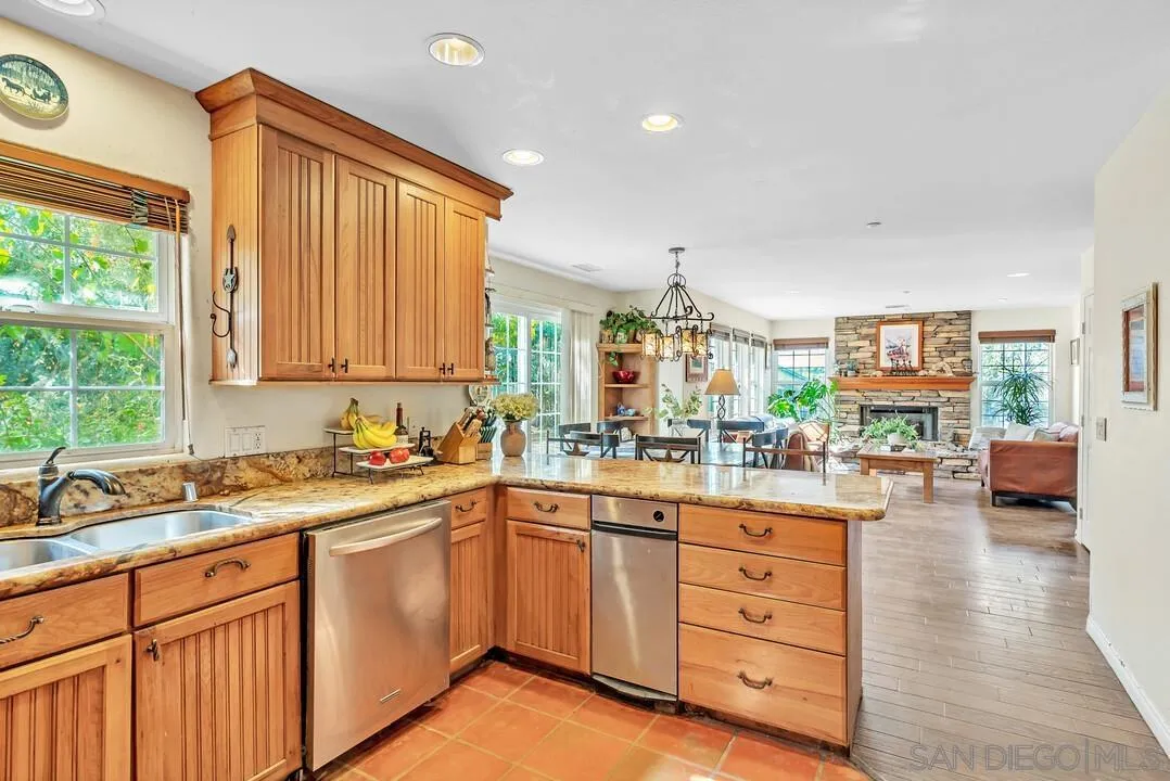 15127 Sycamore Canyon Road Poway, CA 92064 - Photo 22 of 47 a kitchen with a sink window and cabinets