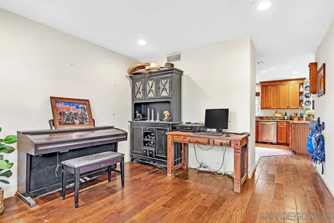 15127 Sycamore Canyon Road Poway, CA 92064 - Photo 23 of 47 a workspace with furniture and a wooden floor