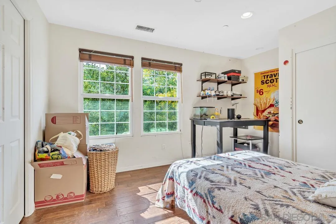15127 Sycamore Canyon Road Poway, CA 92064 - Photo 27 of 47 a bed sitting in a bedroom next to a window