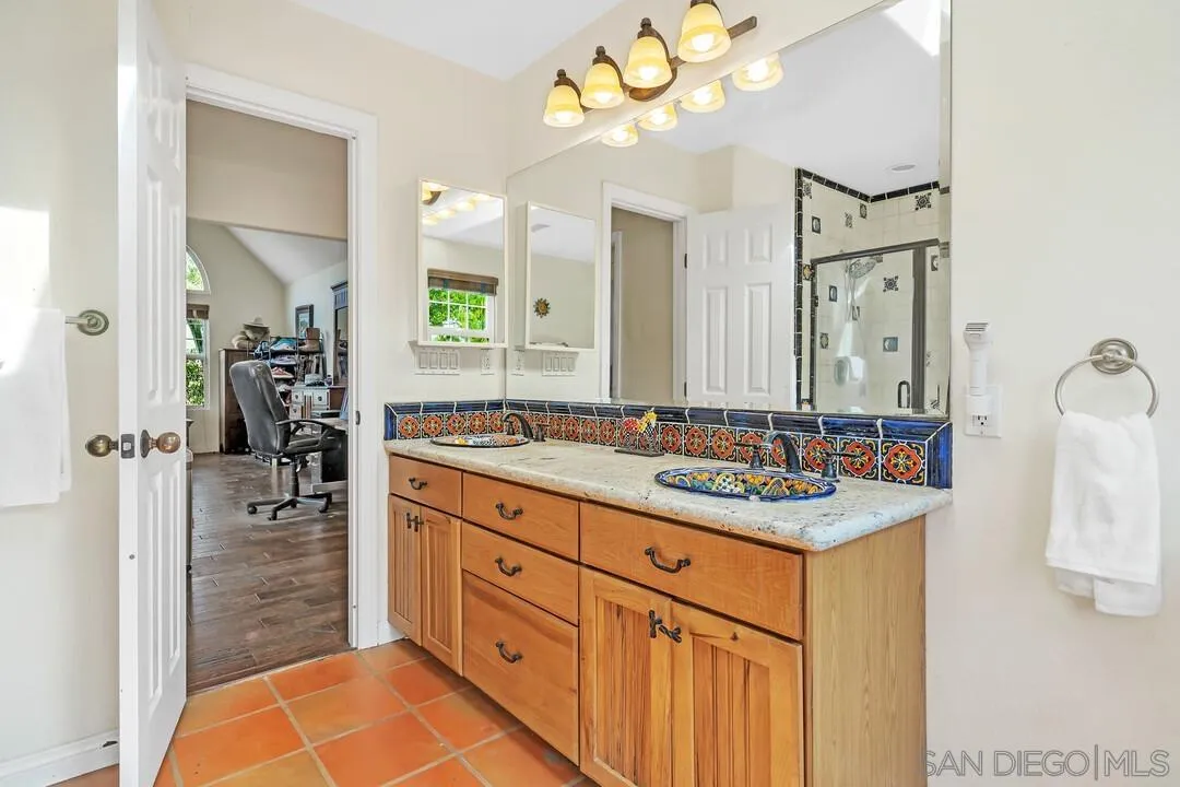 15127 Sycamore Canyon Road Poway, CA 92064 - Photo 32 of 47 a bathroom with a sink double vanity and a mirror