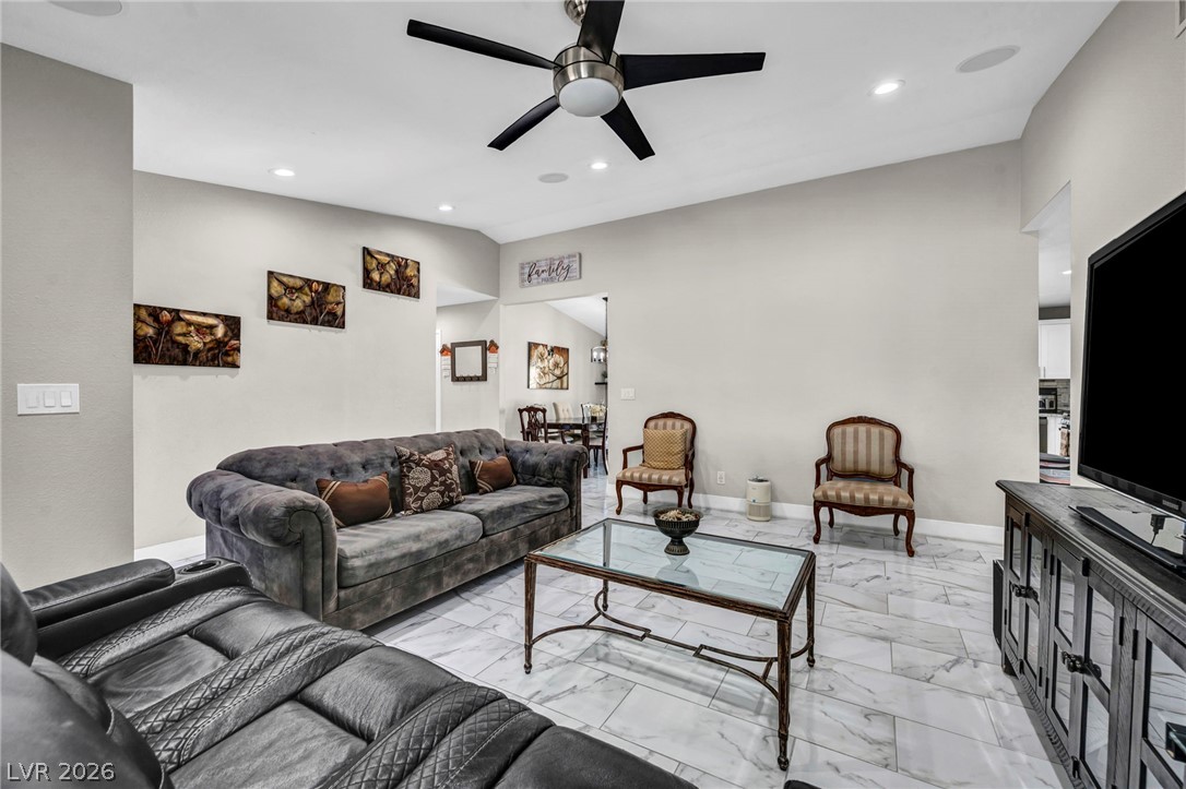 5882 Rio Tinto Way Las Vegas, NV 89110 - Photo 39 of 56 Recessed lighting and a ceiling fan illuminate this living area, offering a relaxed atmosphere with tile flooring.
