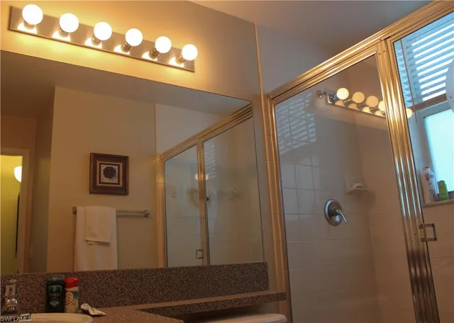 a room with stainless steel appliances kitchen island a table and chairs in it
