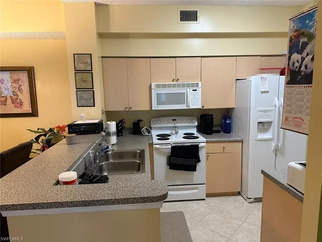 a kitchen with a appliances and cabinets