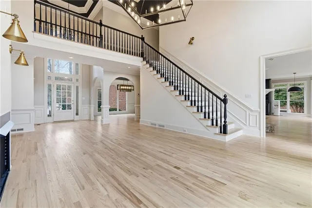 a view of empty room with a fireplace and wooden floor