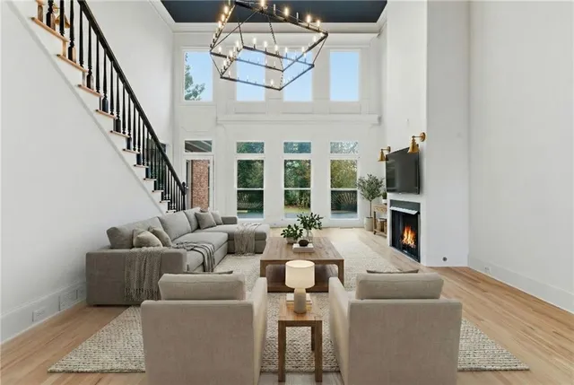 a large kitchen with stainless steel appliances granite countertop a stove a sink and a wooden floors