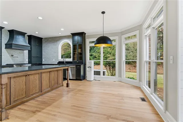 a kitchen with kitchen island stainless steel appliances a sink stove and refrigerator