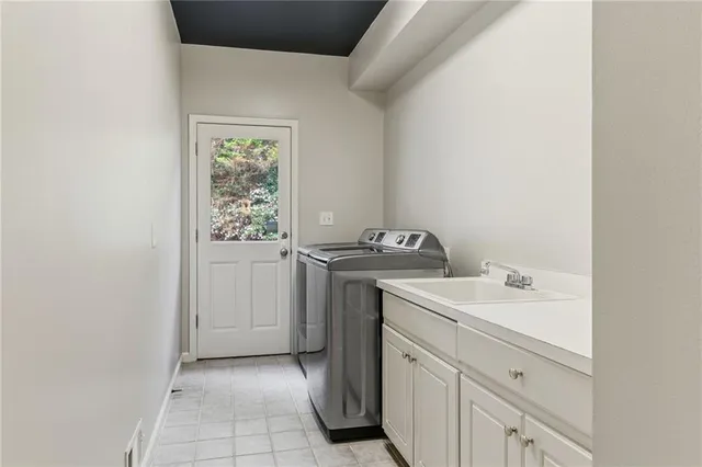 a spacious bathroom with a tub a mirror and sink