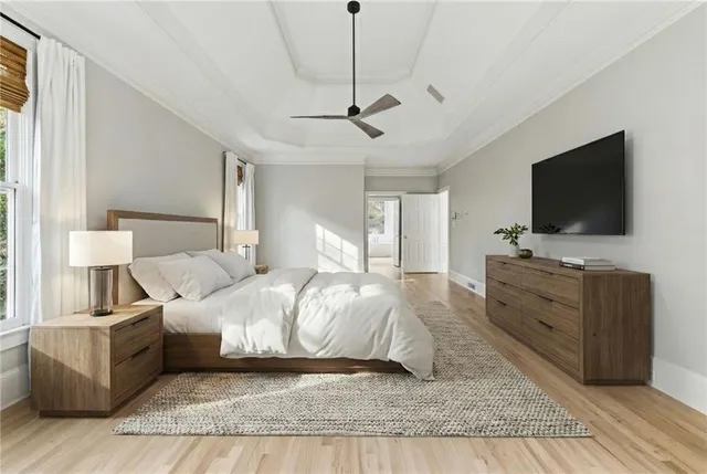 an empty room with chandelier fan and windows