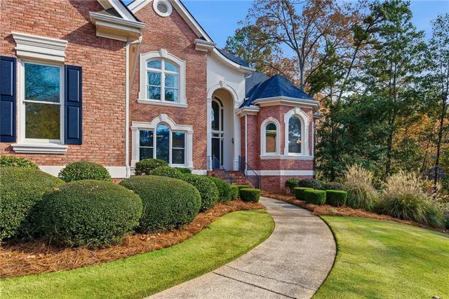a front view of a house with garden