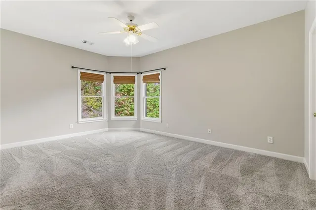 a aerial view of a house with swimming pool and large trees