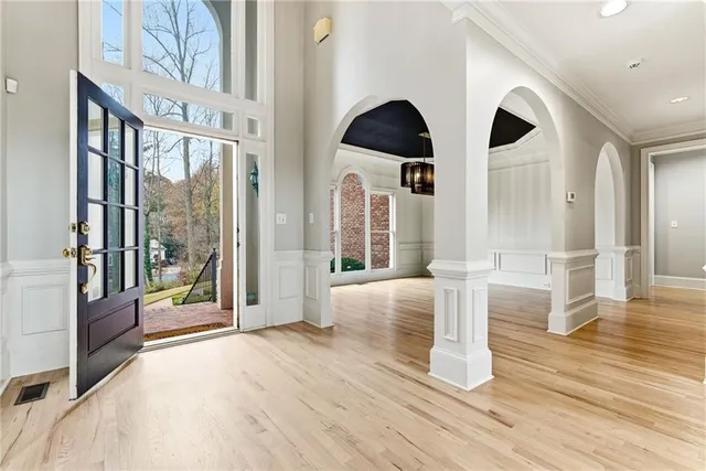 a view of an entryway with wooden floor and door