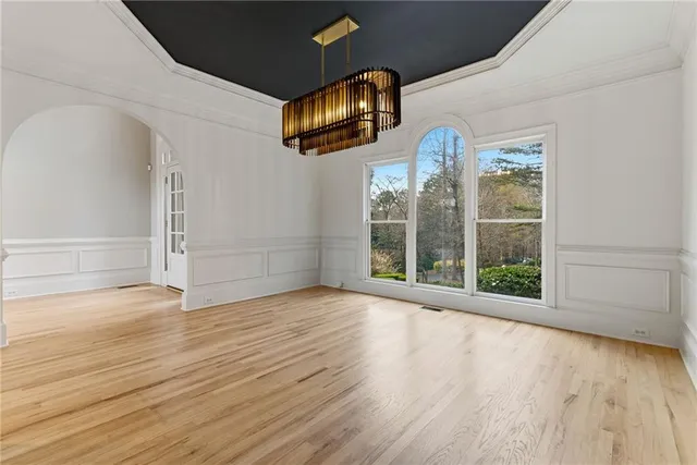 an empty room with wooden floor and fireplace