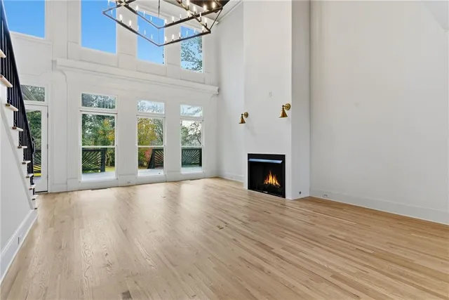 a living room with furniture a flat screen tv and a floor to ceiling window