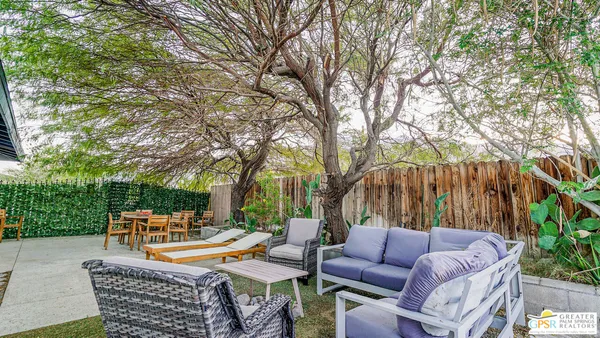 a view of an outdoor sitting area with furniture