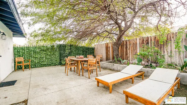 a view of a patio with a table and chairs and a fire pit