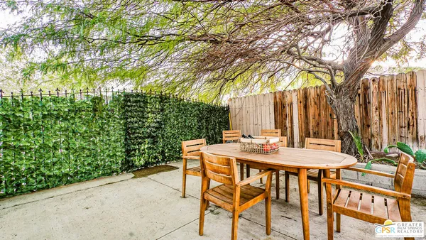 a view of a patio with table and chairs