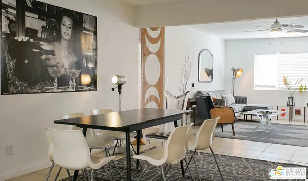 a dining room with furniture and wooden floor