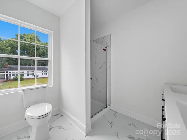 a bathroom with a toilet sink and shower