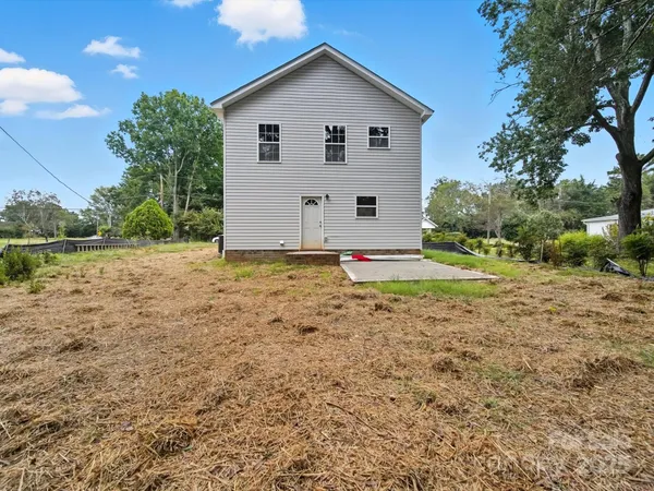 a view of backyard of house with green space