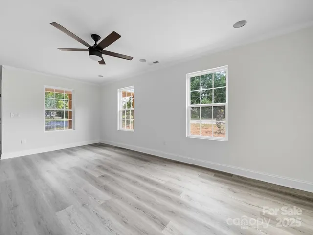 a view of a livingroom with a window and wooden floor