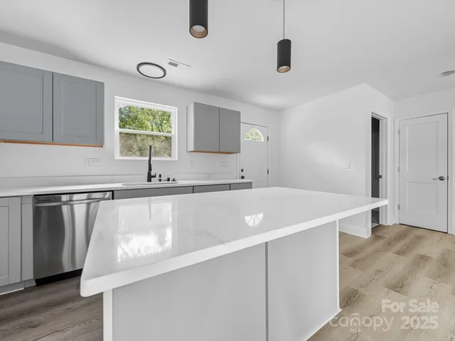 a view of a kitchen with a sink and a window
