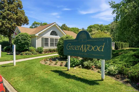 a house with green field in front of it