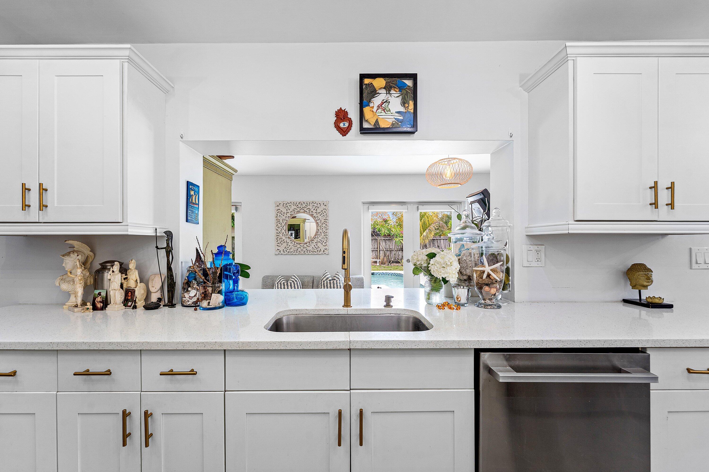 581 Northwest 13th Drive Boca Raton, FL 33486 - Photo 10 of 39 a kitchen with white cabinets and a sink