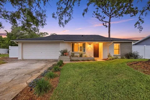 a front view of house with yard and outdoor seating