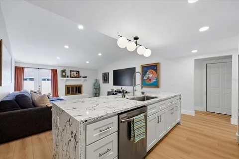 a living room with stainless steel appliances kitchen island furniture and a kitchen view