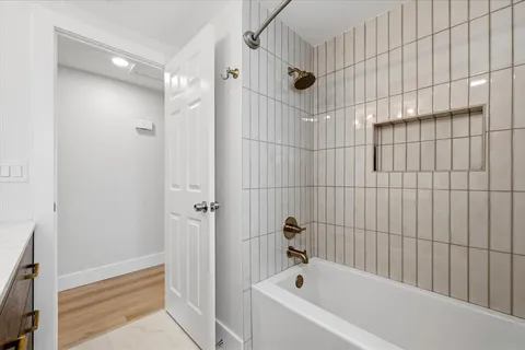 a bathroom with a bathtub and shower