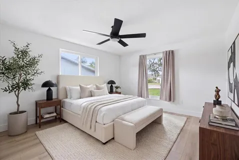 a bedroom with a large bed and a window