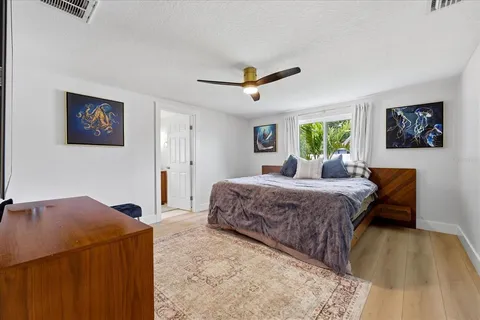 a spacious bedroom with a bed and a table