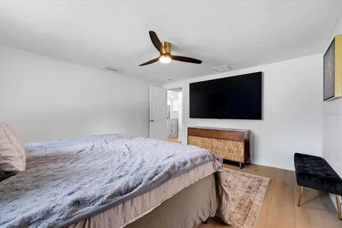 a bedroom with a bed and a flat screen tv