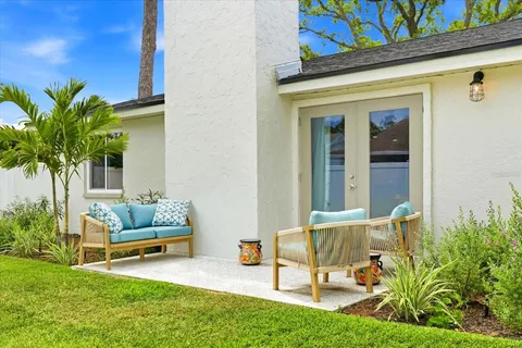 a view of a house with backyard and sitting area