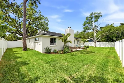a view of a house with backyard and sitting area