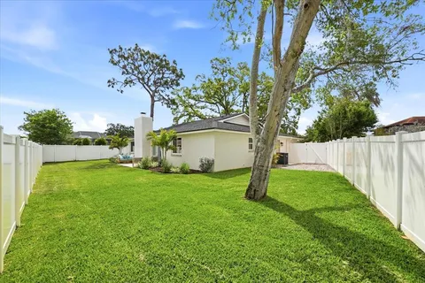 a yellow house in middle of the grass