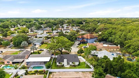 an aerial view of residential houses with outdoor space and street view