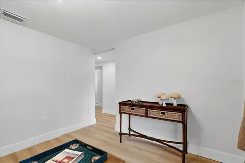a room with wooden floor and furniture