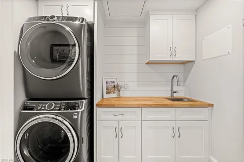 a utility room with sink dryer and washer