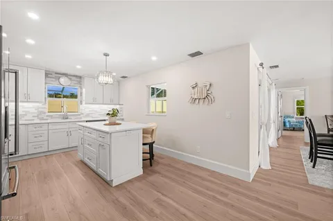 a kitchen with a refrigerator and a stove top oven