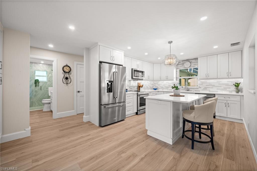 1925 Imperial Golf Course Boulevard Naples, FL 34110 - Photo 16 of 44 Bright, polished, and beautifully curated, this kitchen features generous storage, sleek surfaces, and a seamless integration into the home’s open living layout.