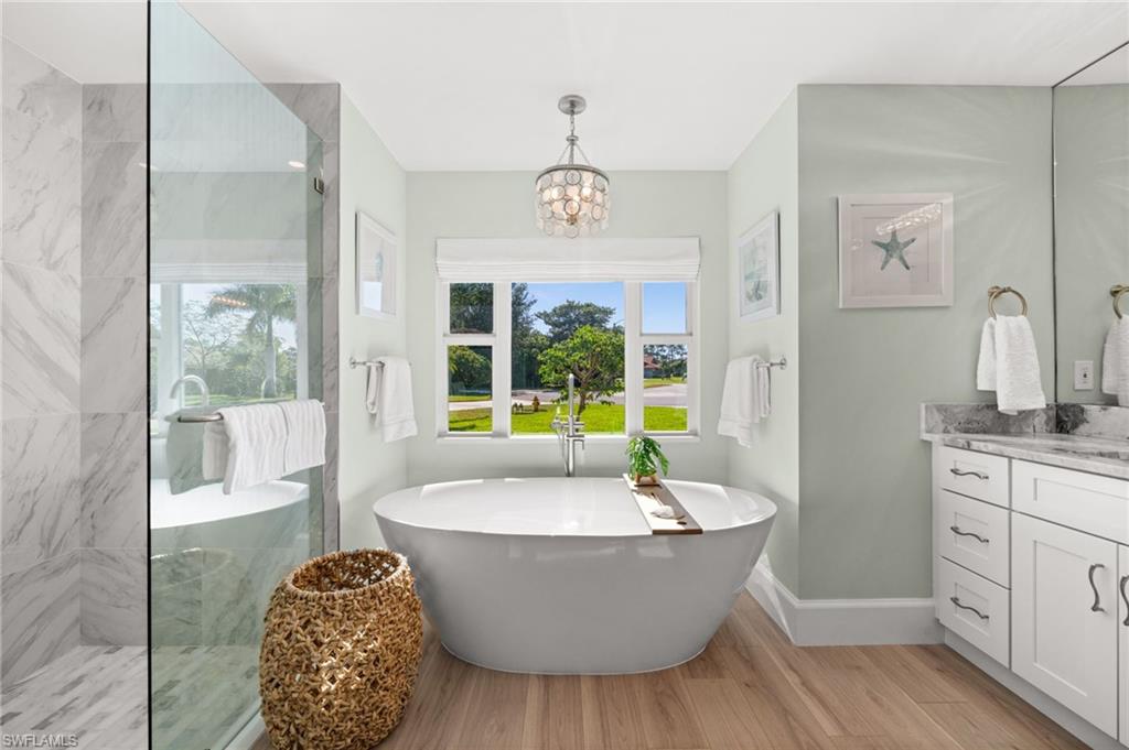 1925 Imperial Golf Course Boulevard Naples, FL 34110 - Photo 23 of 45 A luxurious escape, the freestanding tub and glass shower blend modern luxury with coastal tranquility, creating a peaceful haven within the home.