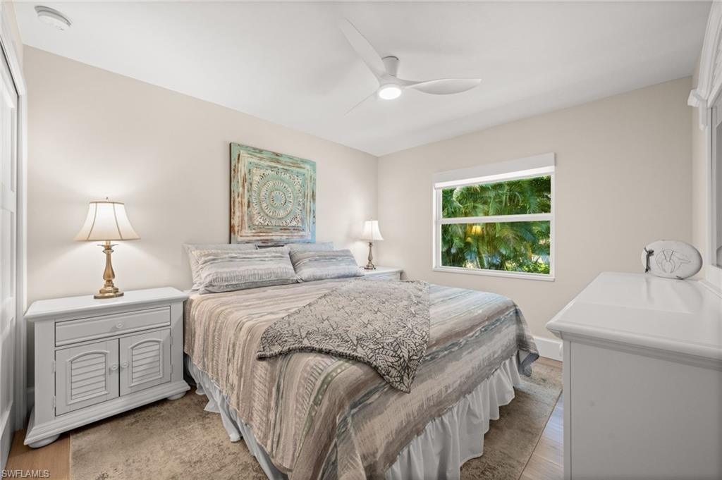 1925 Imperial Golf Course Boulevard Naples, FL 34110 - Photo 27 of 45 A light-filled guest suite designed for comfort, featuring tasteful décor, fresh neutrals, and a private view framed by mature landscaping.