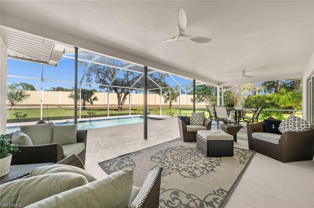 1925 Imperial Golf Course Boulevard Naples, FL 34110 - Photo 35 of 45 An expansive screened lanai designed for year-round enjoyment, with multiple lounging zones, dining space, and serene views of the pool and greenscape.