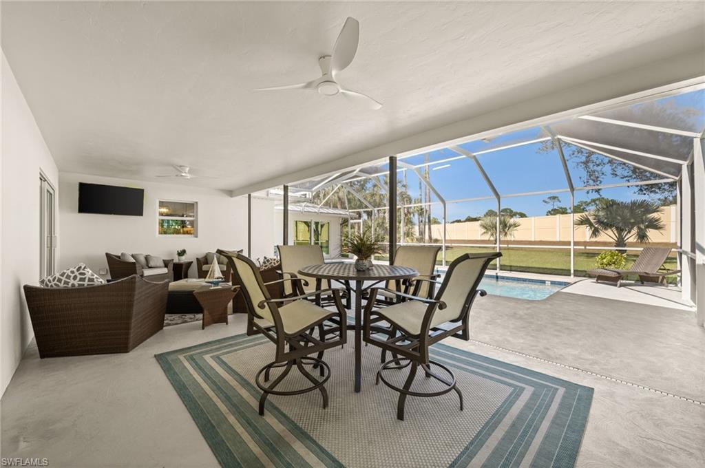 1925 Imperial Golf Course Boulevard Naples, FL 34110 - Photo 36 of 45 Relax, dine, and entertain in style beneath the covered lanai ,offering breezy comfort and a seamless connection to the heated pool and backyard.