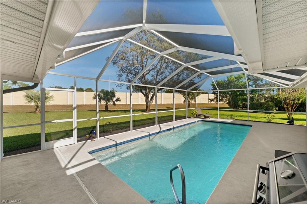 1925 Imperial Golf Course Boulevard Naples, FL 34110 - Photo 37 of 45 A sparkling pool set beneath a soaring screened enclosure, designed for year-round enjoyment, morning laps, and sun-filled afternoons.
